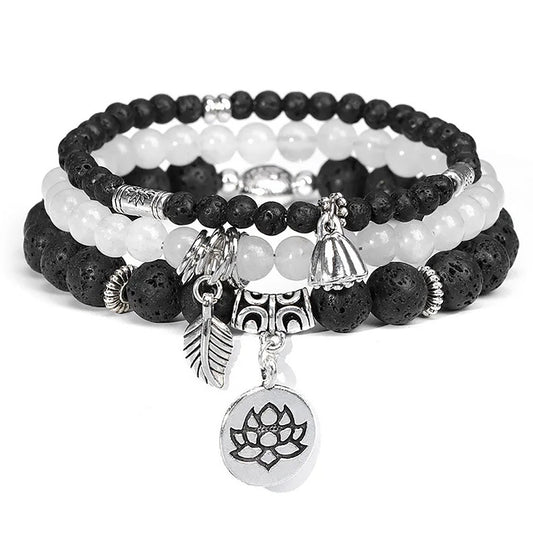 Black Lava Rock & White Agate Charm Bracelets adorned with silve flower themed bead
