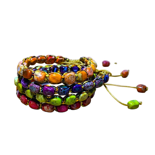 Colorful beaded bracelets on a wooden surface