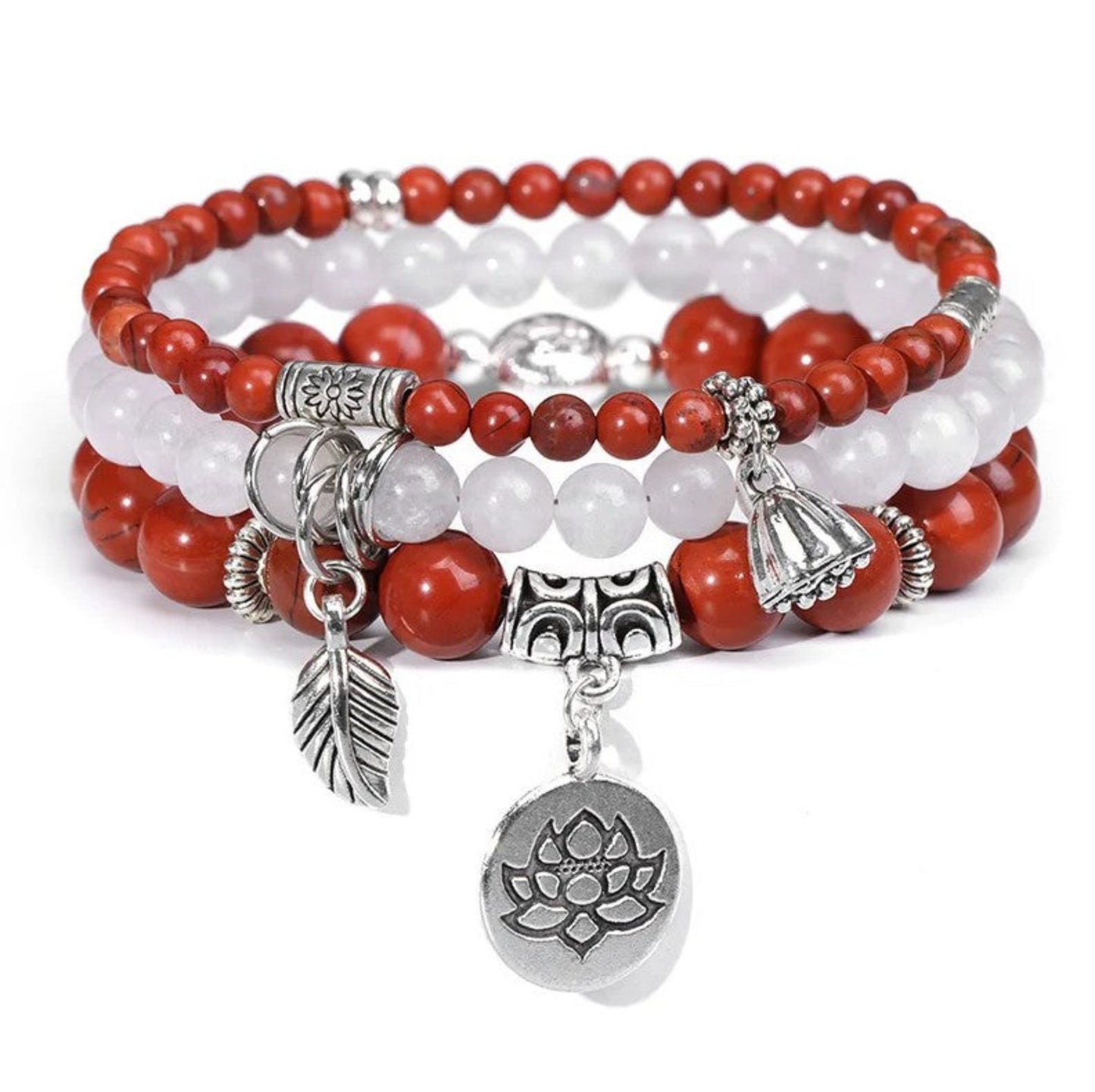 Set of beaded bracelets with silver charms on a white background