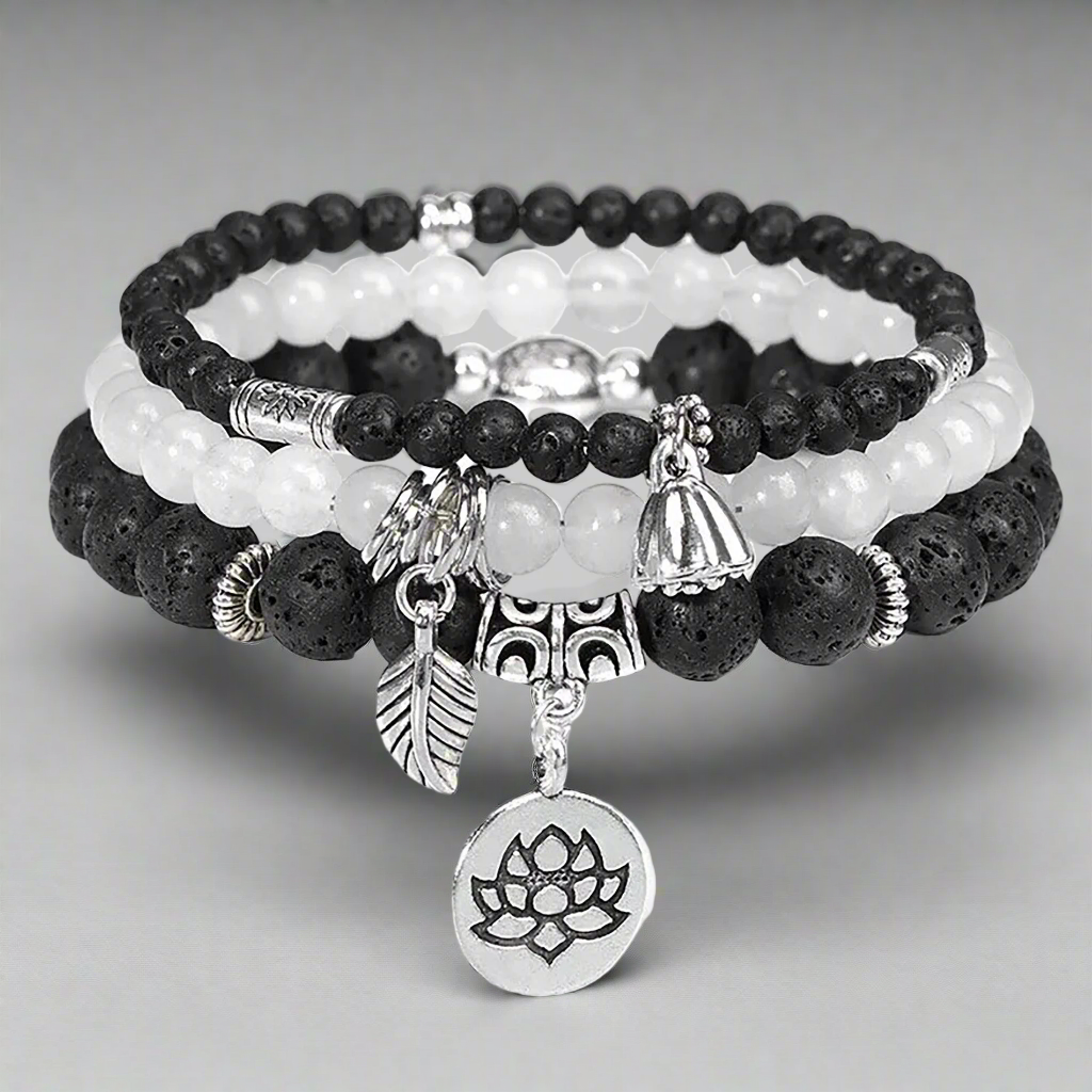 Black Lava Rock & White Agate Charm Bracelets adorned with silve flower themed bead