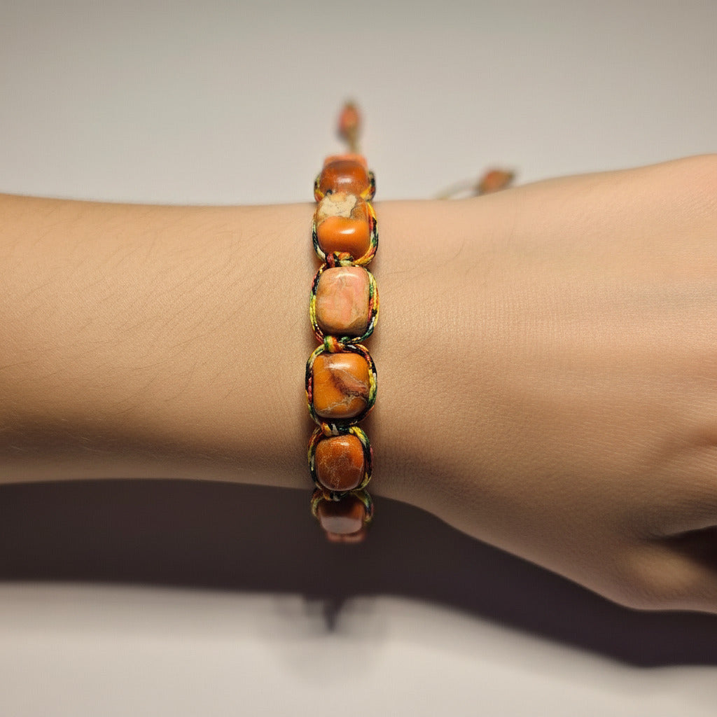 Beaded bracelet on a white cylindrical object with a blurred background
