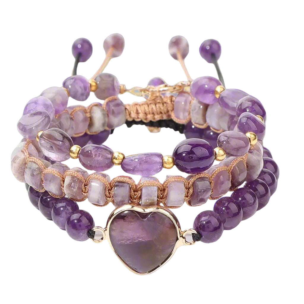 Set of purple beaded bracelets with gold accents on a light purple background