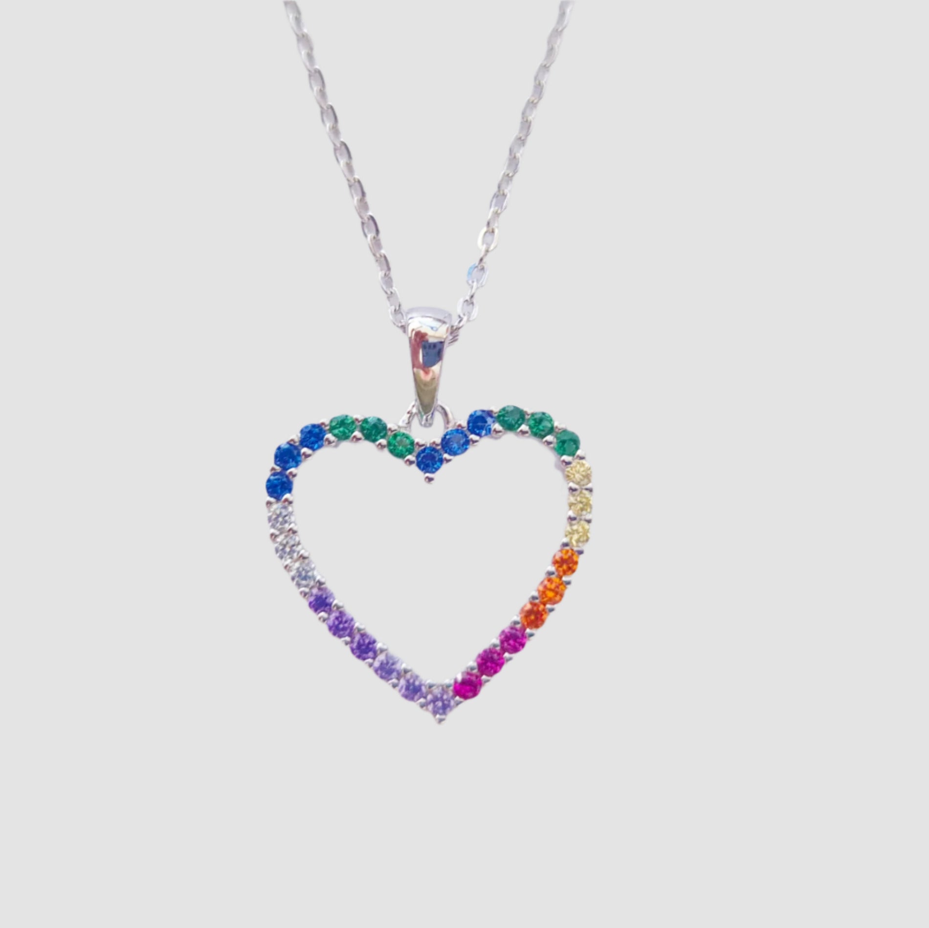 Heart-shaped necklace with colorful stones on a light gray background
