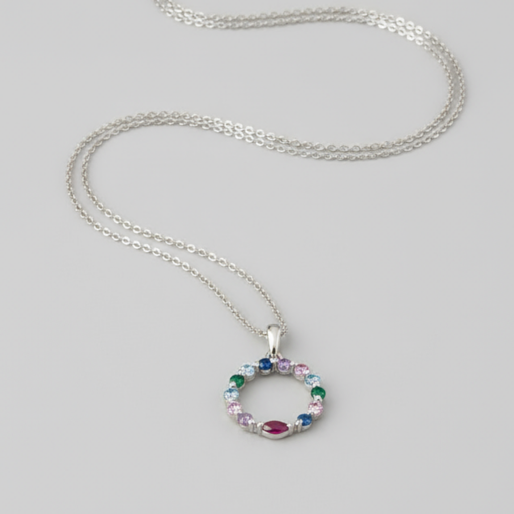 Silver necklace with a circular pendant on a light gray background
